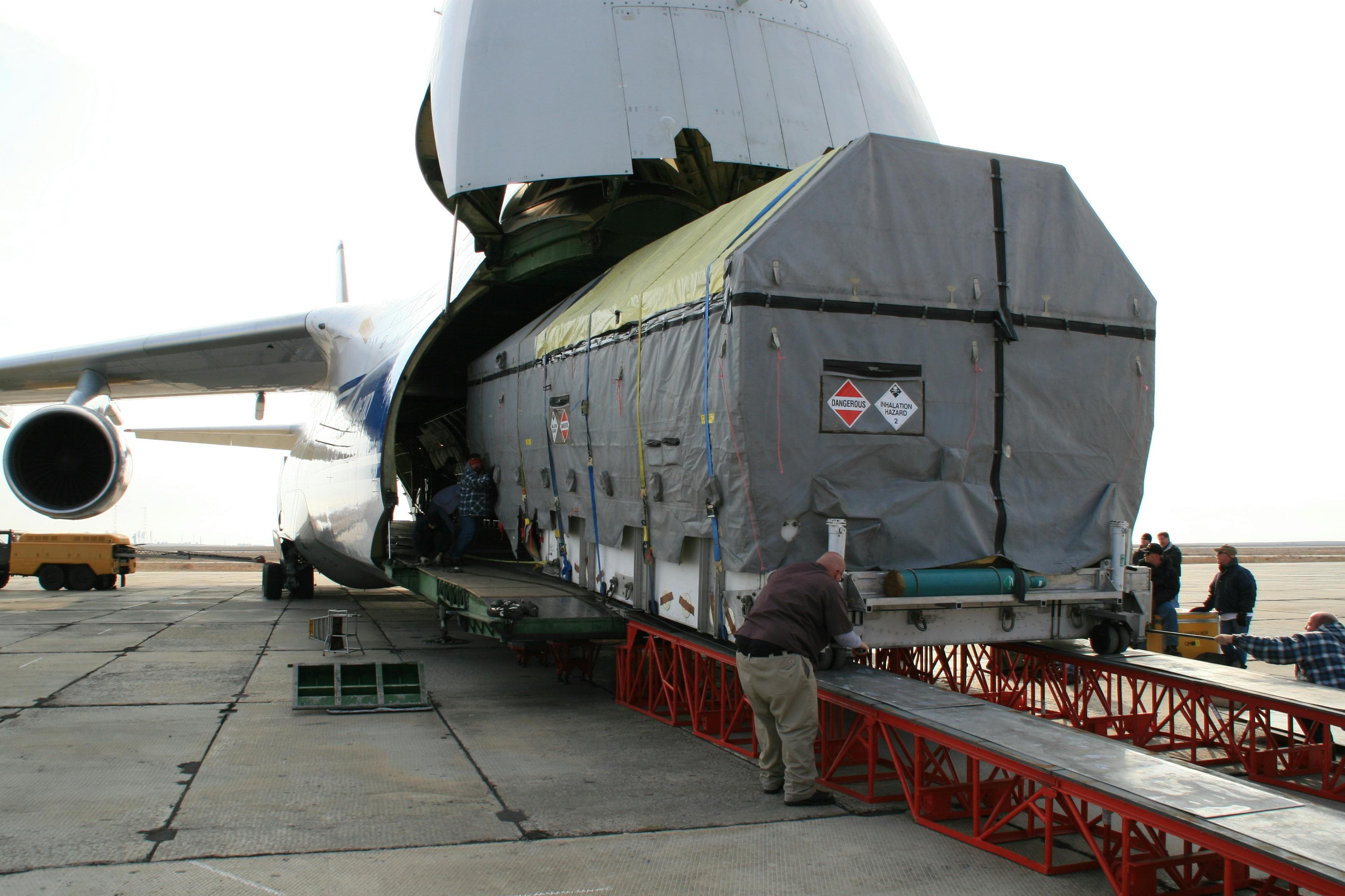 Specialised dangerous-goods cargo being loaded into a heavy-lift cargo aircraft